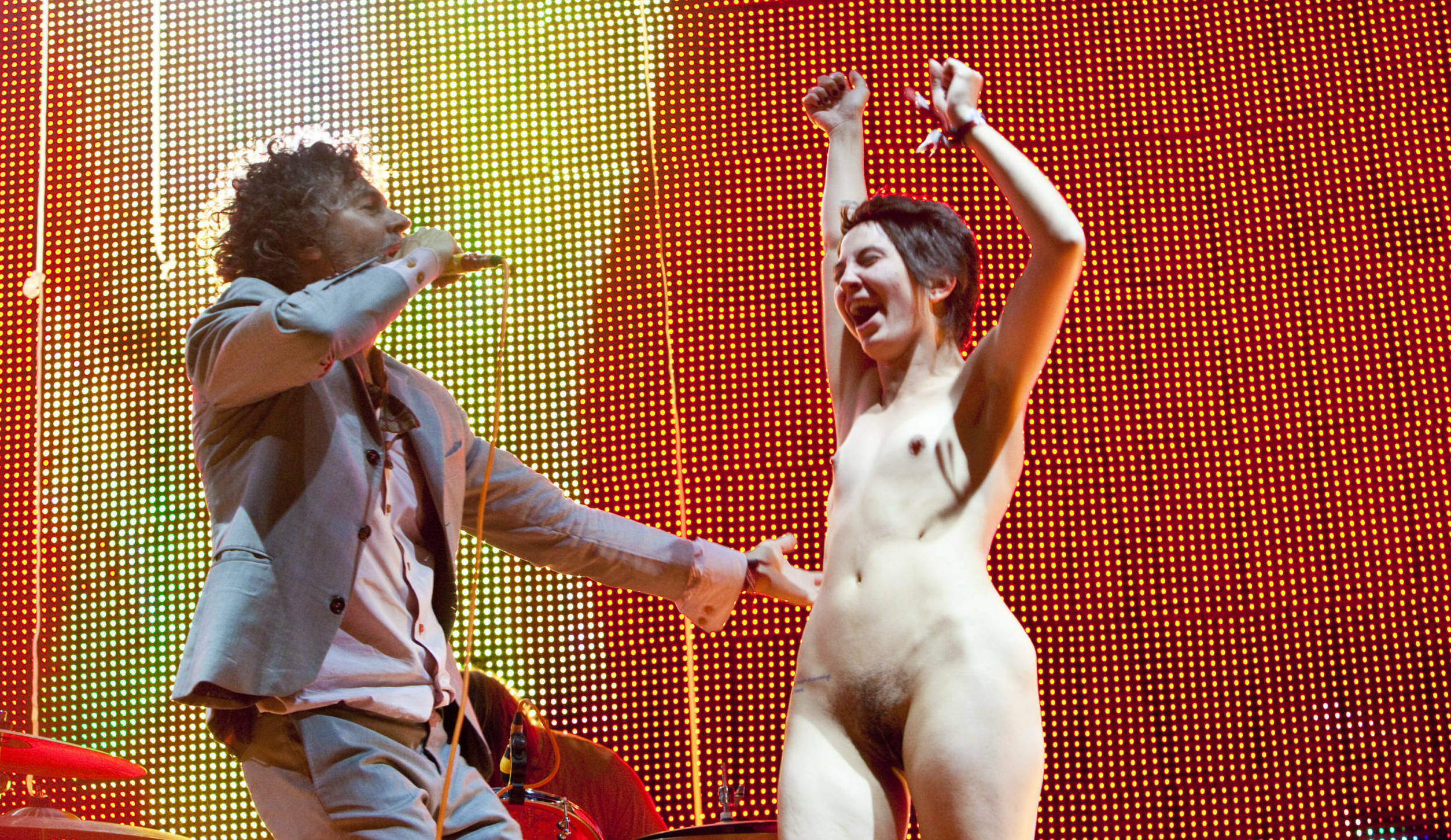 Die Flaming Lips und ein fröhlicher nackter Fan auf der Bühne bei der Voodoo Experience